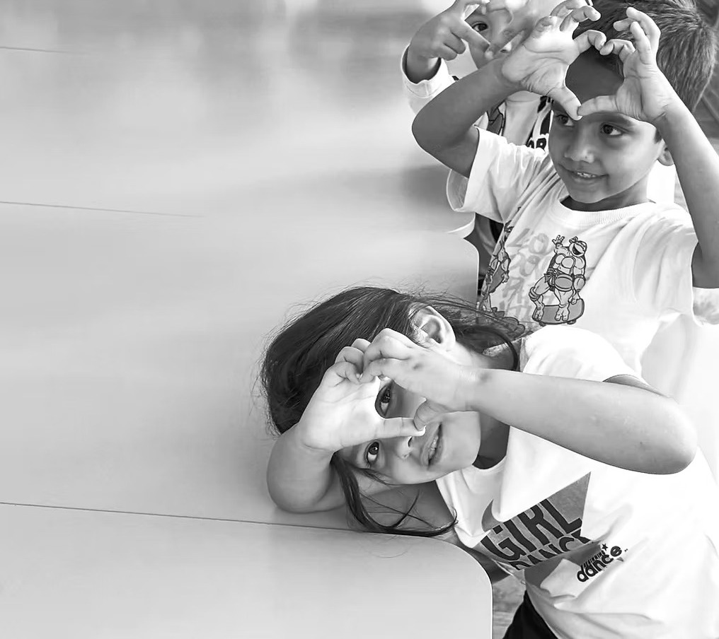Children making heart shapes with their hands in Bulgaria